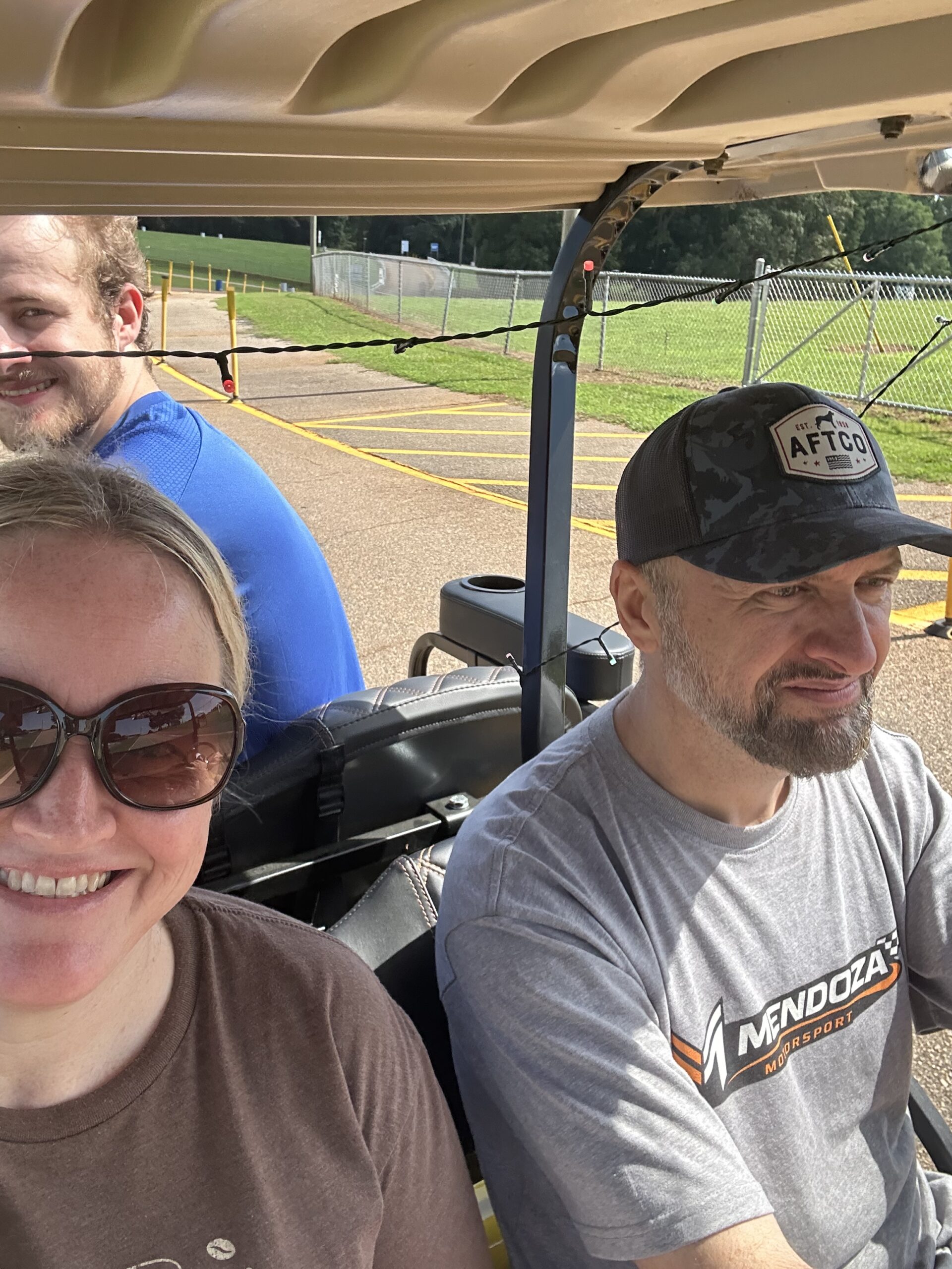 Kyle, Jose, and Avery riding in the golf cart